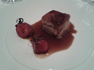 Terrina de cochinillo y anguila con salsa de su propia reducción y tomates infusionados en soja