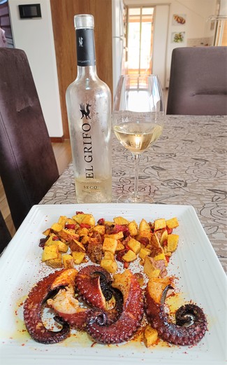 Con un pulpo a la plancha con papas chaucha.