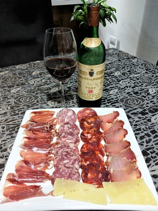 Con el surtido de queso curado al romero, embutidos y jamón ibéricos